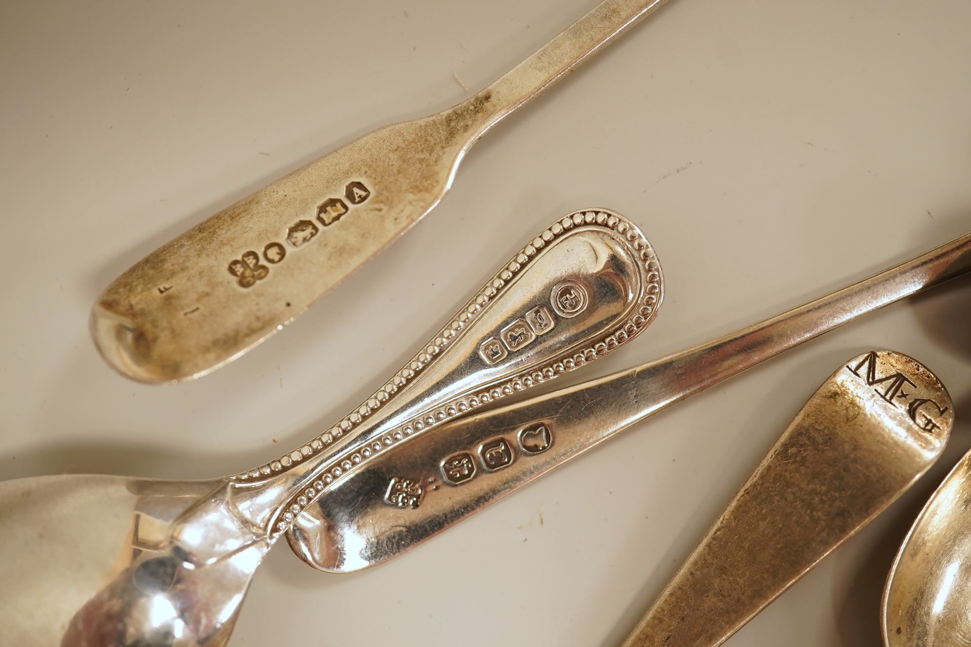 A small quantity of 18th century and later assorted silver teaspoons, various patterns, dates and makers, together with a George V silver pastry fork and two George V silver caddy spoons, 10.7oz.